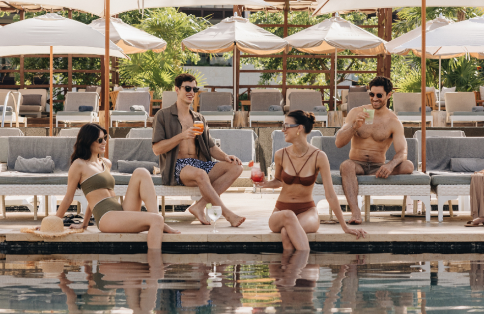 group of people sitting by the pool